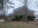 Rear exterior of a brick home with lush landscaping, showcasing the building's architecture and backyard at 1413 Cane St. # 1, North Myrtle Beach, SC 29582