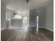 Open-concept living room showcasing modern floors that connect to the white kitchen area at 1413 Cane St. # 1, North Myrtle Beach, SC 29582