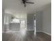 Open-concept living room showcasing modern floors that connect to the white kitchen area at 1413 Cane St. # 1, North Myrtle Beach, SC 29582