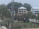 Multi-level waterfront home featuring palm trees and private playground at 1413 Cane St. # 1, North Myrtle Beach, SC 29582