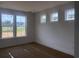 Bright bedroom featuring three windows, freshly painted white walls, and clean design for comfort at 147 Joyce Dr, Longs, SC 29568