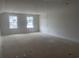 Spacious bonus room featuring natural light, freshly painted white walls, offering versatility at 147 Joyce Dr, Longs, SC 29568