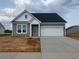 Charming one-story home with gray siding, white trim, a two-car garage, and a concrete driveway at 147 Joyce Dr, Longs, SC 29568