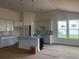 Modern kitchen with white cabinets, an island, and pendant lighting, blending style and functionality at 147 Joyce Dr, Longs, SC 29568