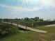 View of a waterfront community with a wooden bridge at 14A Salt Marsh Cove # 14A, Pawleys Island, SC 29585