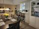 Bright dining room features a table with flower centerpiece and breakfast bar looking into kitchen at 14A Salt Marsh Cove # 14A, Pawleys Island, SC 29585