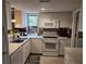 Modern kitchen with white cabinetry, marble countertops, and stainless steel appliances at 14A Salt Marsh Cove # 14A, Pawleys Island, SC 29585