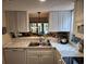 Bright kitchen with marble countertops and stainless steel appliances overlooking dining area and pond at 14A Salt Marsh Cove # 14A, Pawleys Island, SC 29585