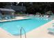 A community swimming pool with a shallow end and many lounge chairs for residents to relax at 14A Salt Marsh Cove # 14A, Pawleys Island, SC 29585