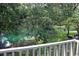 Enjoy the tranquil water views from this home's porch, with lush trees surrounding the area at 14A Salt Marsh Cove # 14A, Pawleys Island, SC 29585