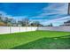 Expansive green backyard enclosed by a white fence, offering privacy and space for recreation at 1527 Swing Bridge Way, Myrtle Beach, SC 29588