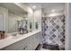 Bathroom featuring double sink vanity with white cabinetry, large mirror, and stylish shower curtain at 1527 Swing Bridge Way, Myrtle Beach, SC 29588