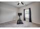 A simply decorated bedroom features carpet, ceiling fan, window, and a stationary exercise bike at 1527 Swing Bridge Way, Myrtle Beach, SC 29588