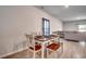 A cozy dining area features a wooden table set with seating for six, next to the living area at 1527 Swing Bridge Way, Myrtle Beach, SC 29588