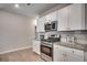 Well-equipped kitchen with stainless steel appliances, modern cabinetry, and wood-look flooring at 1527 Swing Bridge Way, Myrtle Beach, SC 29588