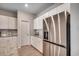 Bright kitchen with stainless steel refrigerator, white cabinets, and granite countertops at 1527 Swing Bridge Way, Myrtle Beach, SC 29588