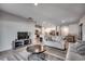 Open-concept living room flowing into a kitchen with white cabinetry and stainless steel appliances at 1527 Swing Bridge Way, Myrtle Beach, SC 29588