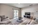 Living room showcasing sliding glass doors to the backyard, with contemporary furniture and decor at 1527 Swing Bridge Way, Myrtle Beach, SC 29588