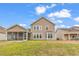 Back of a home with a manicured lawn, a screened-in porch, and a bay window at 1616 Deltura Dr., Myrtle Beach, SC 29588