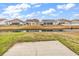 Backyard view of several homes with nice yards, a body of water, and covered porches at 1616 Deltura Dr., Myrtle Beach, SC 29588