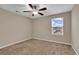 Cozy bedroom with plush carpet, a ceiling fan, and a window providing natural light at 1616 Deltura Dr., Myrtle Beach, SC 29588