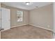 This is a bedroom with neutral paint and carpet, a window, and a ceiling light at 1616 Deltura Dr., Myrtle Beach, SC 29588