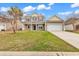 Charming two-story home featuring a manicured lawn, inviting porch, and attached two-car garage at 1616 Deltura Dr., Myrtle Beach, SC 29588