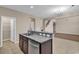 Stylish kitchen island with granite countertops and a stainless steel dishwasher, adjacent to living area at 1616 Deltura Dr., Myrtle Beach, SC 29588