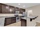 Modern kitchen with stainless steel appliances, granite countertops, and dark wood cabinetry at 1616 Deltura Dr., Myrtle Beach, SC 29588