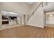 Open-concept living space with hardwood floors, a staircase, and an adjoining kitchen at 1616 Deltura Dr., Myrtle Beach, SC 29588