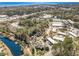 An aerial view showcases a community near a pond and lush green surroundings at 17 Racquet Club Dr., Pawleys Island, SC 29585