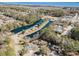 A picturesque aerial view shows waterfront home near ponds and lush green trees at 17 Racquet Club Dr., Pawleys Island, SC 29585