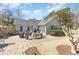 An inviting brick back patio features comfortable seating and a serene outdoor living space at 17 Racquet Club Dr., Pawleys Island, SC 29585