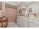 Cozy bathroom featuring tiled floor, white vanity, large mirror, and a patterned shower curtain at 17 Racquet Club Dr., Pawleys Island, SC 29585