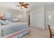 Carpeted bedroom featuring traditional furniture, ceiling fan and access to a bathroom and closets at 17 Racquet Club Dr., Pawleys Island, SC 29585