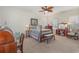 Inviting bedroom featuring a decorative ceiling fan, carpeted floors, and a large window at 17 Racquet Club Dr., Pawleys Island, SC 29585