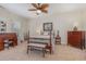 Charming bedroom with carpeted floors, wooden furniture, a decorative ceiling fan, and a large window at 17 Racquet Club Dr., Pawleys Island, SC 29585