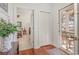 Bright entryway with hardwood floors leads to a bedroom and a screened porch with comfortable seating at 17 Racquet Club Dr., Pawleys Island, SC 29585