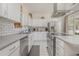 Well-lit kitchen equipped with stainless steel appliances and white subway tile backsplash at 17 Racquet Club Dr., Pawleys Island, SC 29585