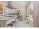 Sunlit kitchen with a stainless steel refrigerator, a central island, and stylish bar stools at 17 Racquet Club Dr., Pawleys Island, SC 29585