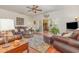 Spacious living room featuring hardwood floors, a ceiling fan, and ample seating at 17 Racquet Club Dr., Pawleys Island, SC 29585