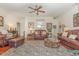 Inviting living room with leather furniture, ceiling fan, area rug and beautiful hardwood flooring at 17 Racquet Club Dr., Pawleys Island, SC 29585