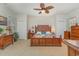 Spacious main bedroom featuring carpet floors, ceiling fan, a large bed, and two closets at 17 Racquet Club Dr., Pawleys Island, SC 29585