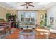 Bright sunroom with skylights, large windows, hardwood floors, and comfortable seating at 17 Racquet Club Dr., Pawleys Island, SC 29585