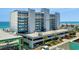 Condo building exterior featuring multi-level parking and blue accents near the beach at 1709 S Ocean Blvd. # 510, North Myrtle Beach, SC 29582