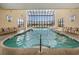 Indoor pool featuring a glass ceiling and floor to ceiling window views at 1709 S Ocean Blvd. # 510, North Myrtle Beach, SC 29582