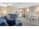 Comfortable living room featuring blue sofas, a dining area, and an open floor plan to the kitchen at 1709 S Ocean Blvd. # 510, North Myrtle Beach, SC 29582