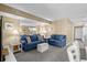 Inviting living room with soft blue couches and a mirrored wall reflecting the open kitchen at 1709 S Ocean Blvd. # 510, North Myrtle Beach, SC 29582