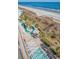 An aerial view of a beachside resort's landscaping and walkway to a sandy beach with ocean views at 1903 S Ocean Blvd. # 701, North Myrtle Beach, SC 29582