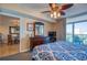 Bedroom with ocean views, a ceiling fan, and a dresser with a mirror and a television at 1903 S Ocean Blvd. # 701, North Myrtle Beach, SC 29582